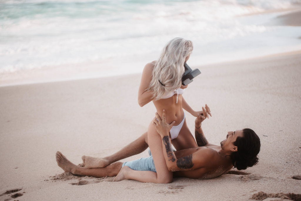 taking-pictures-laying-on-boyfriend-at-beach