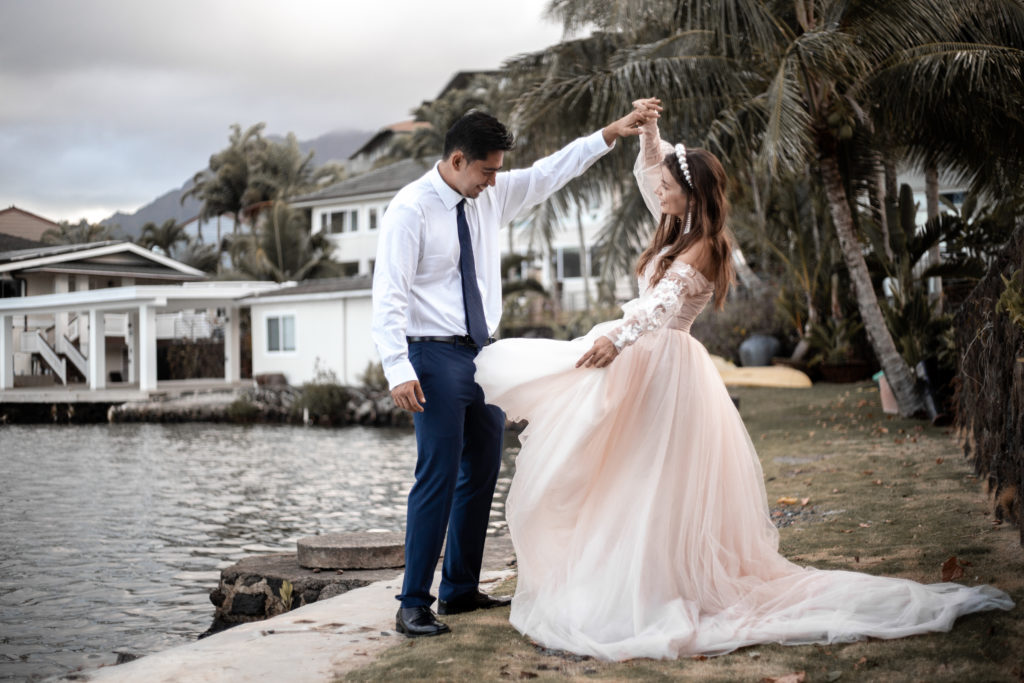 alohi estate wedding couple outside by the water smiling