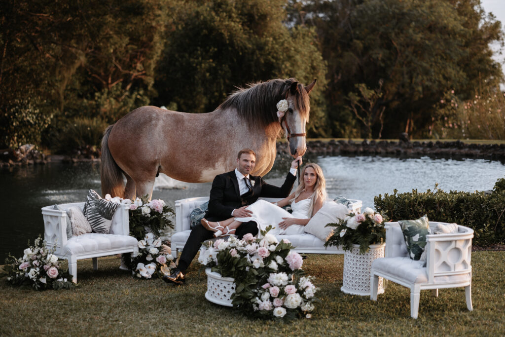 Sunset Ranch Wedding Photo of couple with horse at Charlie's Pond