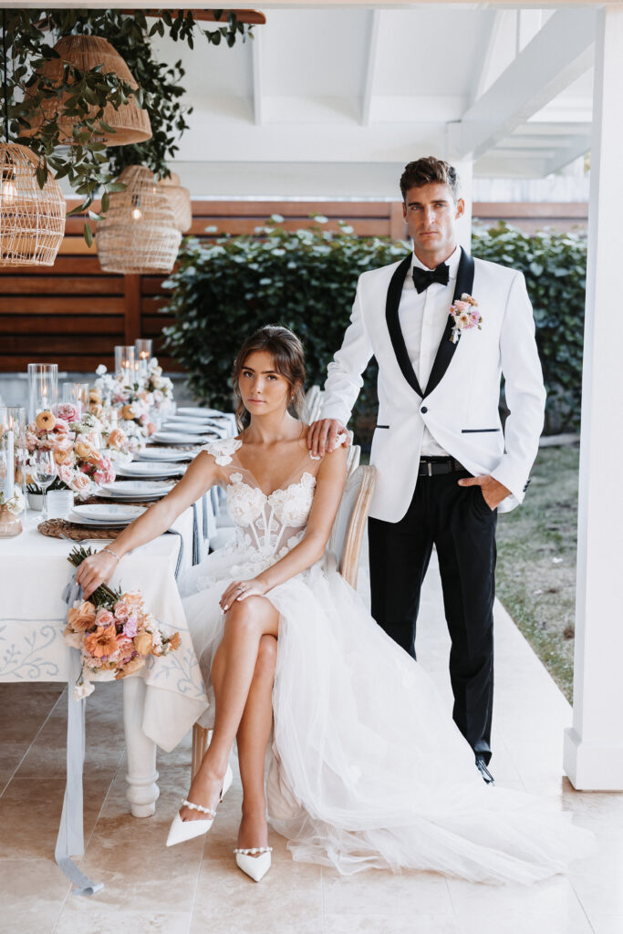 Editorial style photo of bride and groom seated at table