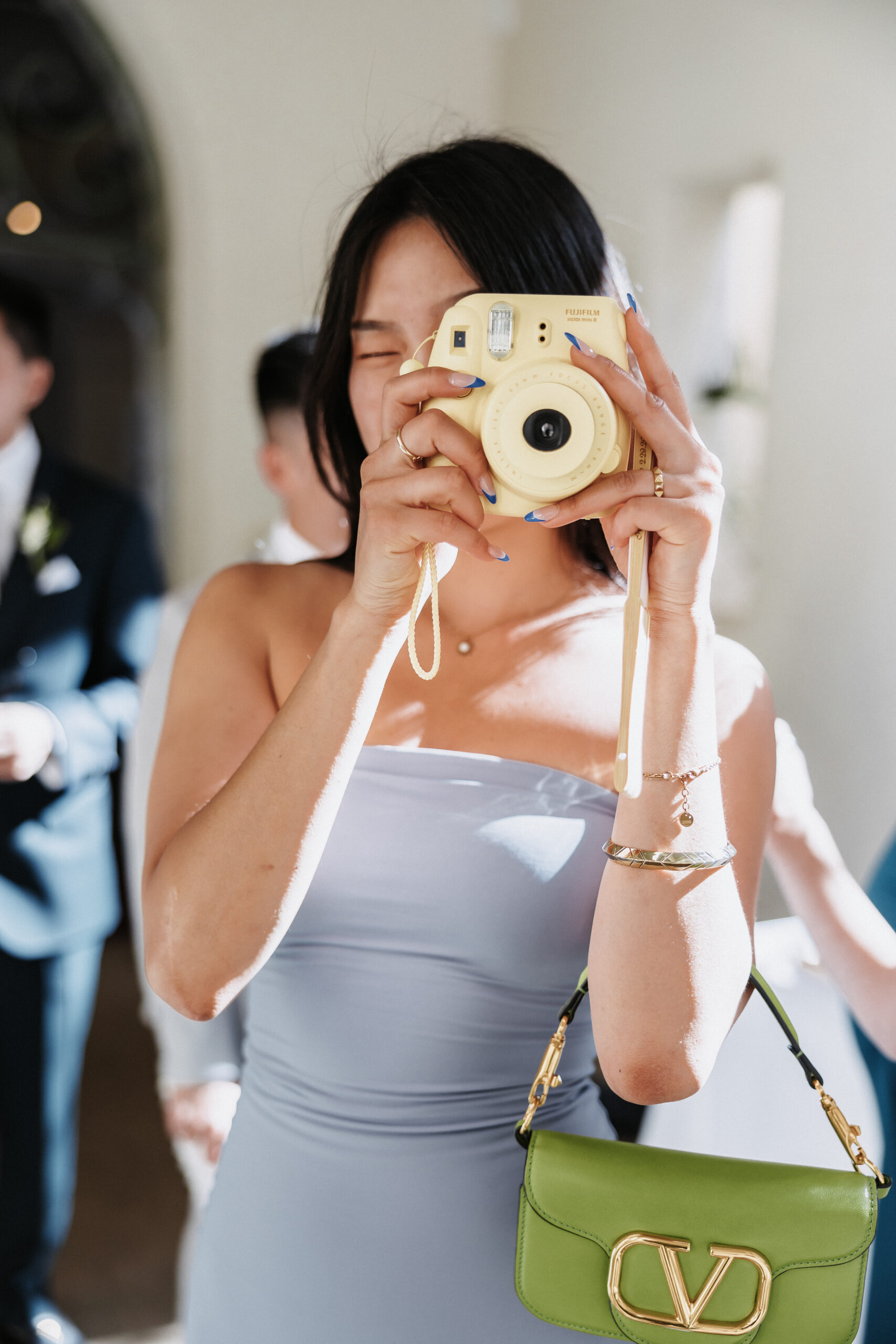 wedding guest holding a film camera