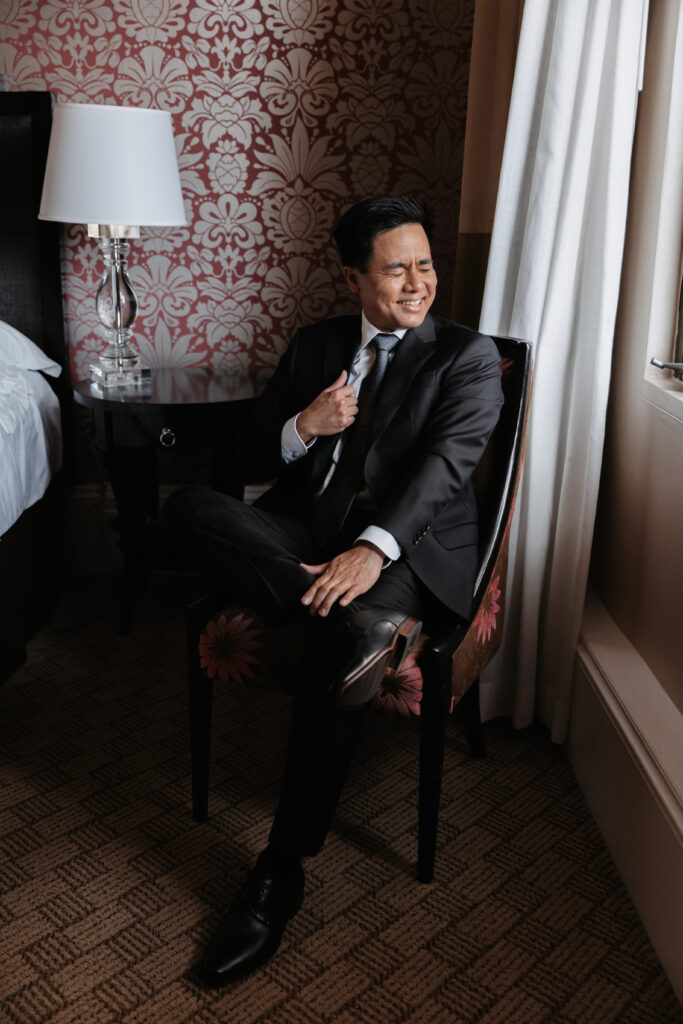 Royal Hawaiian Hotel Room on Oahu groom getting ready in his suit.