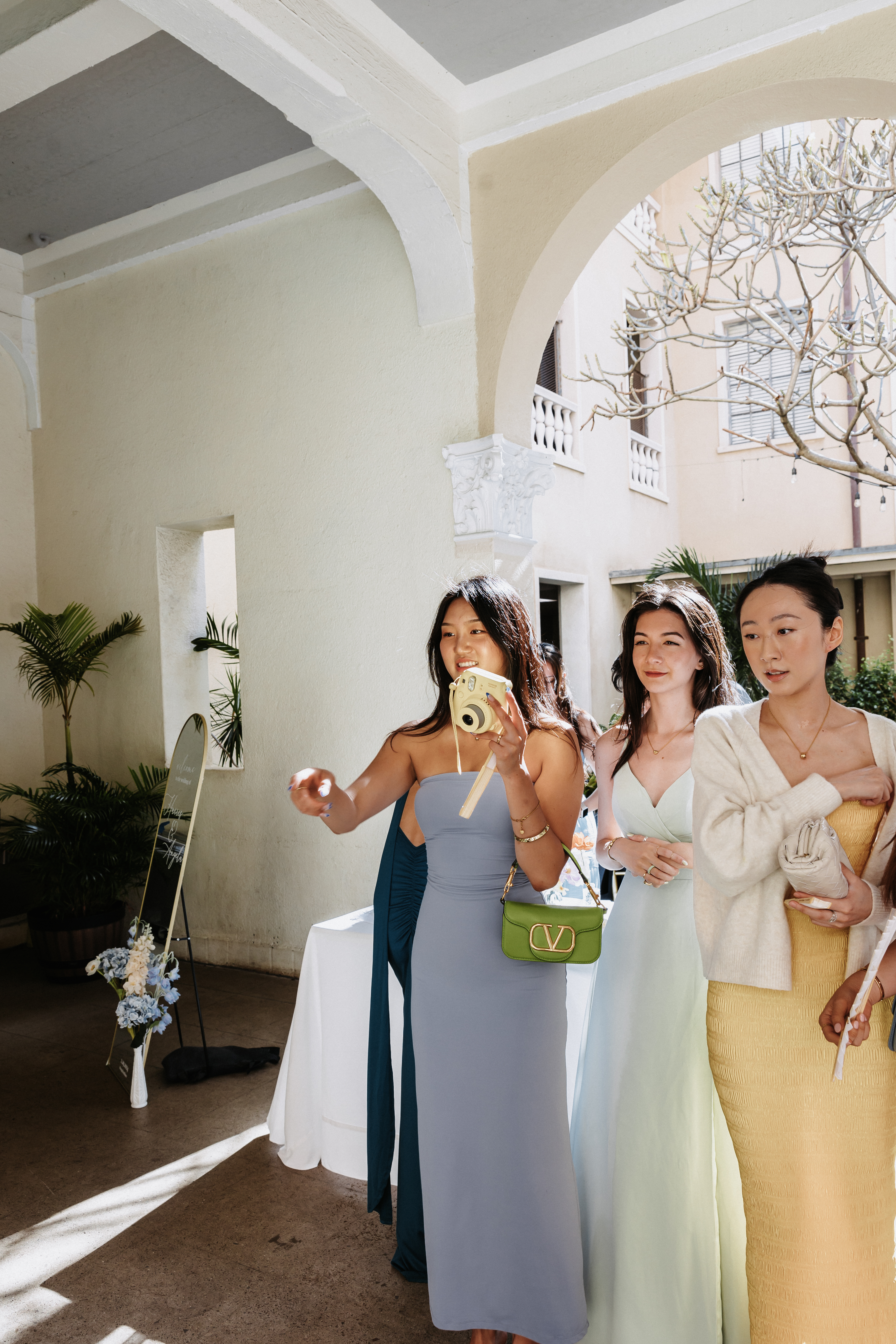 bridesmaids in multicolor spring inspired dresses at cafe julia hawaii