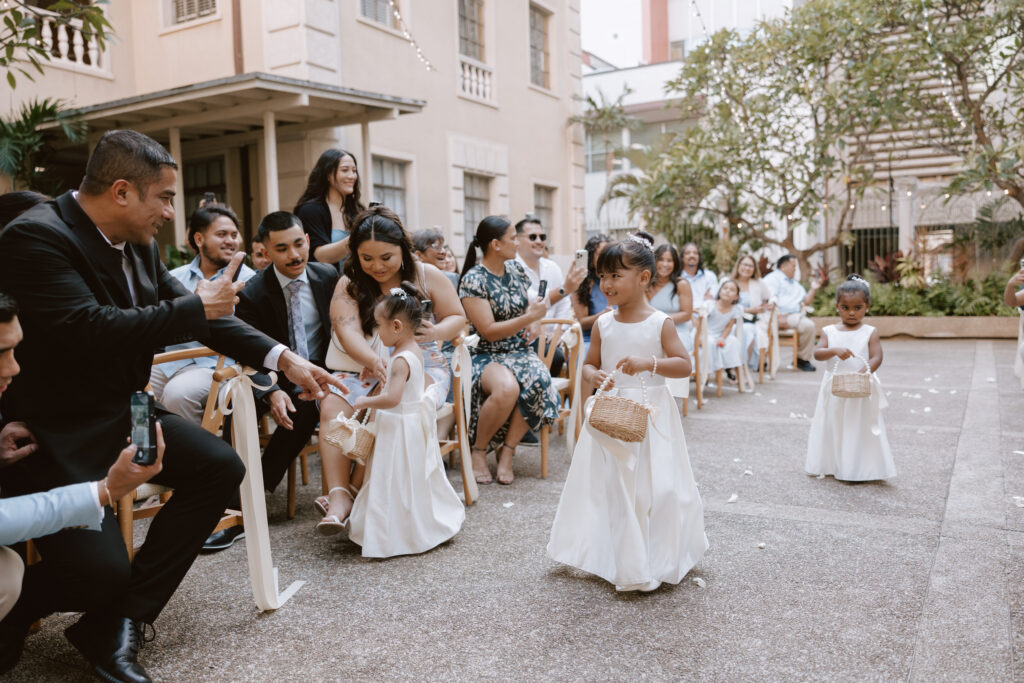 Adorable flower girls and ring bearer walking down the aisle during a Cafe Julia wedding ceremony, capturing a heartfelt and storytelling moment.