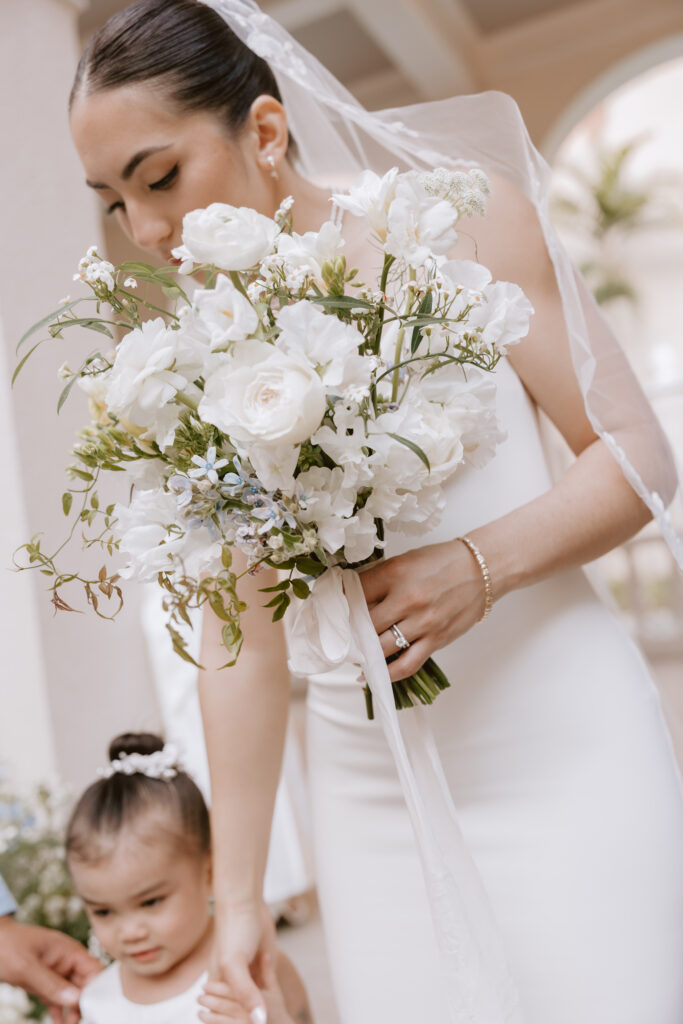 Close-up of the bride's bouquet featuring lush tropical flowers and elegant greenery, captured at a Cafe Julia wedding to highlight fine art storytelling.