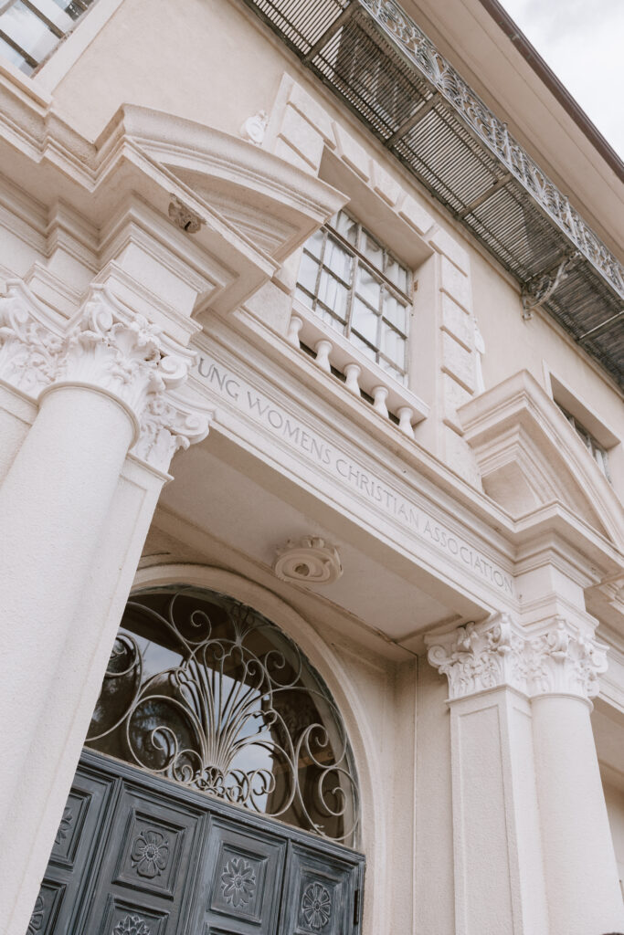 Elegant front view of Cafe Julia’s historic Mediterranean Revival architecture, showcasing its grand arches and timeless charm as a premier wedding venue.