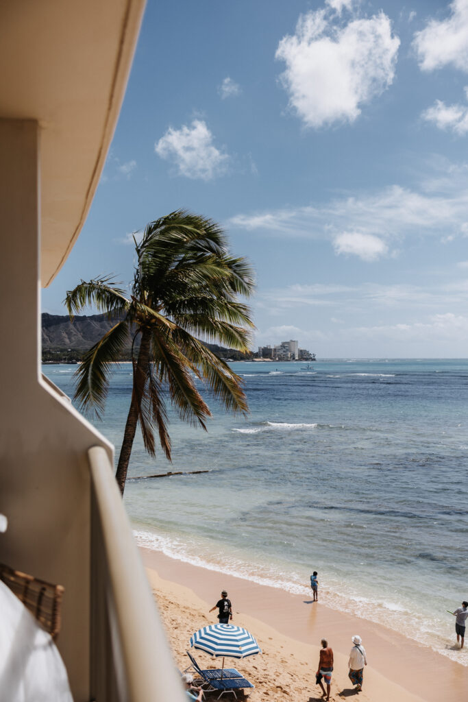 Couple looking at view off the balcony at a Hawaiian resort.