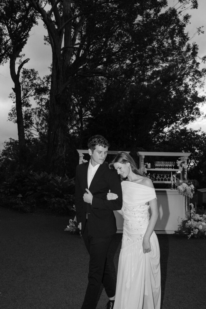 Bride and groom walking hand-in-hand through Sunset Ranch, showcasing storytelling through candid wedding photography.