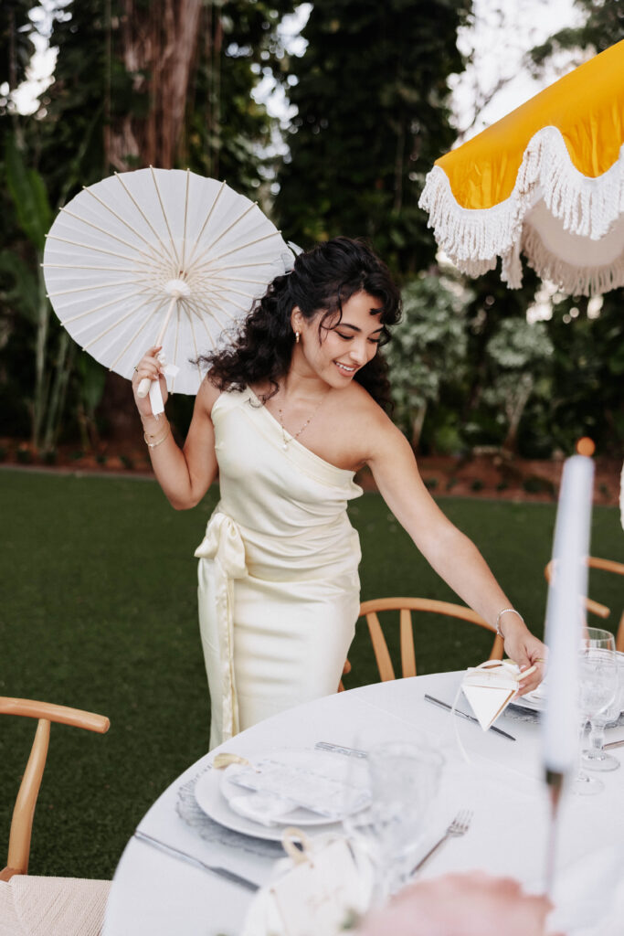 Bridesmaid looking at the guest favors happily, telling the story of the couples wedding.